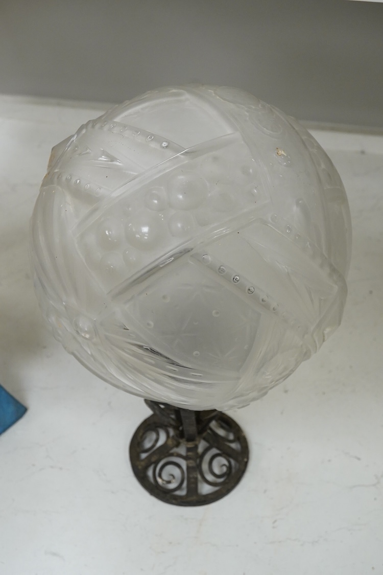 An Art Deco wrought and cast iron ceiling light with pressed glass shade, 44cm high